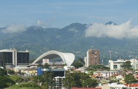 SAN JOSE, COSTA RICA - JUNE 18, 2012: View to the National Stadium and buildings with mountains at the background in San Jose, Costa Rica.